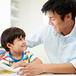 Father Helping Son With Homework
