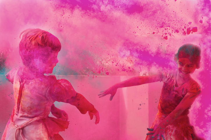 Two little kids playing with gulal on holi.